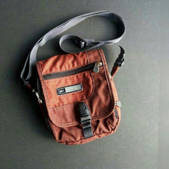 REI Handbags - REI travel day crossbody in rust orange